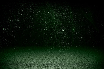 Wall Mural - neon green dusty on a black background