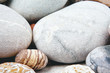 Mix of rounded multicolor textured stones on sea beach . Close up coast shoot