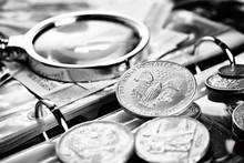 Silver Dollar And Numismatic Coins With Magnifying Glass