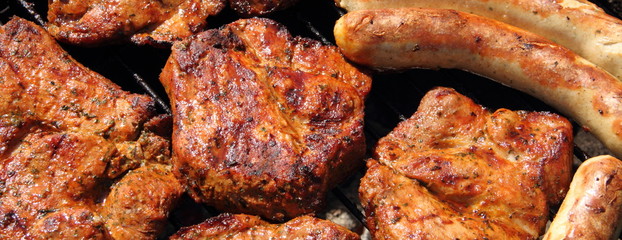 various meat and sausages on the charcoal grill