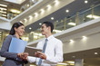 © ImageHit - Business partners discussing by using tablet