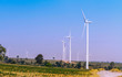 Wind turbines power generator over blue sky at farmer field