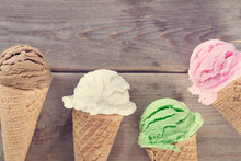 Close-up Of Ice Cream Cones On Wooden Table