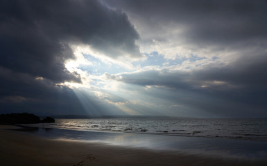 Wall Mural - Rays of autumn sunlight breaking through the cloud at the beach of Big Sand near Gairloch in the Scottish Highlands, Scotland, UK.