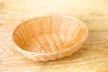 Wall Mural - 
Oval shaped wicker basket on a wooden table