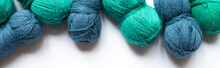 Top View Of Blue And Green Wool Yarn On White Background, Panoramic Orientation