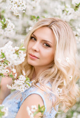 portrait of a woman in a blooming garden.