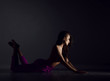 © Dmitry Lobanov - Young beautiful brunette woman in purple trousers and naked upper body and breast lying on floor in sexy pose and stretching