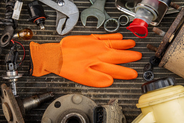 Car repair background with copy space. Variety of tools and oil and paint spray cans layered out on a user radiator background.