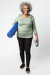 © rawpixel.com - Happy black senior woman with a yoga mat and a water bottle
