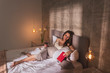 © Impact Photography - Pregnant woman relaxing in bed in the morning
