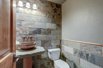 Absolutly stunning bathroom interior deisgn in a luxury rustic cabin style American home with stone and wood, venetian plaster and caling tones on nature.