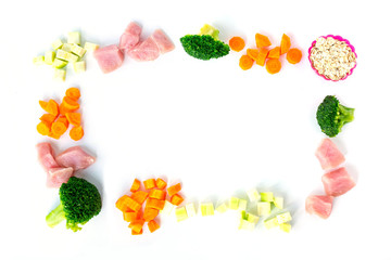 Frame ingredients oat, meat, zucchini, broccoli, carrot for healthy pet food natural on white background. Copy space. Flat lay.