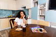 © LIGHTFIELD STUDIOS - curly african american woman holding cup with coffee near tasty breakfast and smartphones with blank screen