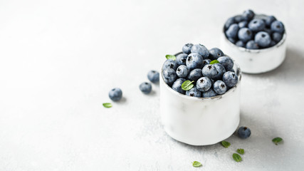 Wall Mural - Fresh blueberries on a small ceramic bowl. Selective focus,copy space.