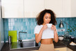 © LIGHTFIELD STUDIOS - curly african american girl looking at cup of coffee
