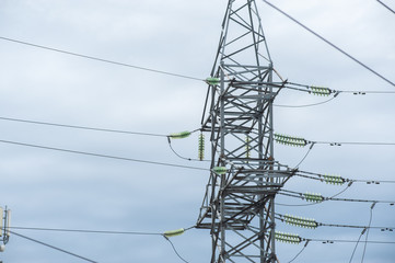 Electric post with wires. Transmission tower. Close up high voltage power lines. High voltage electric transmission pylon tower.