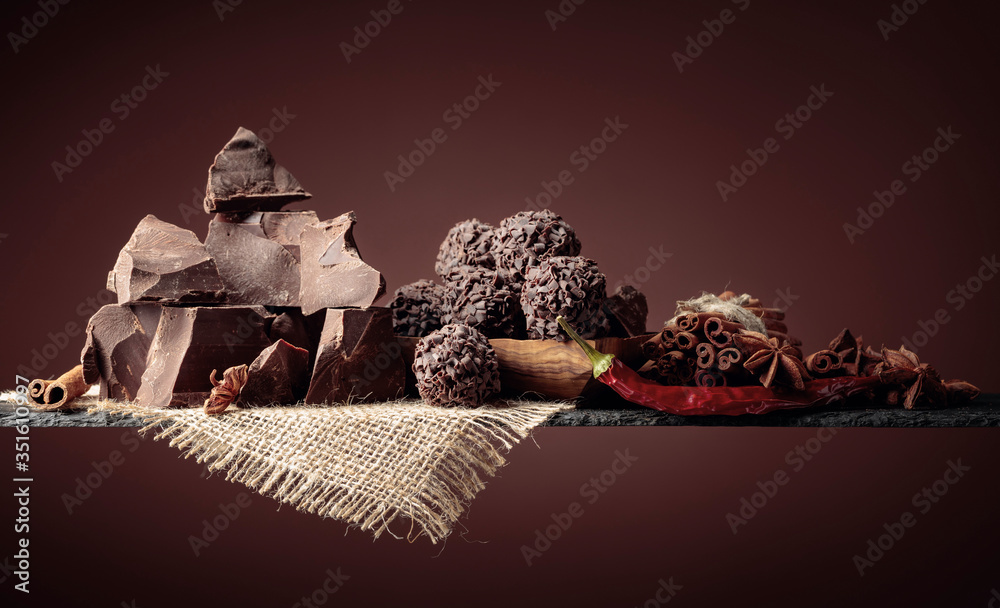 Chocolate truffles with broken pieces of chocolate and spices. - obrazy, fototapety, plakaty 