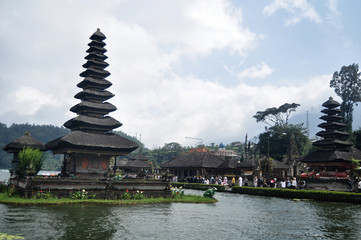 Meru towers of Pura Ulun Danu Bratan or Pura Bratan Hindu Shaivite Shiva temple archaeological site for travelers people travel visit and respect praying in Lake Bratan near Bedugul in Bali, Indonesia