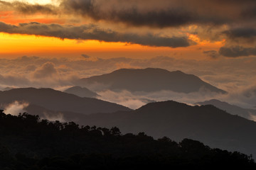 Wall Mural - Costa Rica sunset landscape. Hills of Tapantí nationl park cloud forest, Costa Rica. Tropical mountains with white storm clouds. Rainy day in the forest. Tropic landscape in Cetral America, sunset.