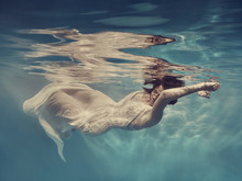 Portrait Of A Girl In A Dress Floating Underwater