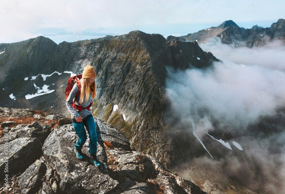 Hiking adventures woman trail running in mountains with backpack solo travel outdoor summer vacation trip in Norway healthy lifestyle concept - obrazy, fototapety, plakaty 