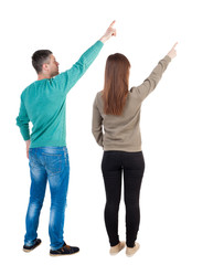 Canvas Print - Back view of couple in sweater pointing.