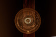 Stara old school, symetryczna lampa na drewnianej lakierowanej belce, lampa sufitowa, żarnik w kształcie spirali w szklanej bańce