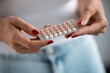 Woman holding a contraceptive pills. Concept of contraception methods.