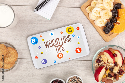 Healthy Tablet Pc compostion with WEIGHT LOSS TIPS inscription, weight loss concept