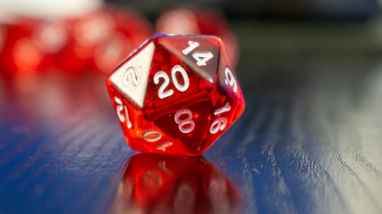 Red roll dice on a black table