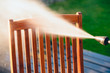 power washing garden furniture - made of exotic wood - shallow depth of field
