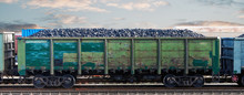 Railway Wagon Loaded With Coal. Coal Freight Train At The Railway Station. Coal Wagon, Mining And Transportation Of Minerals By Rail