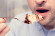 © Анастасия Семашко - Person having breakfast with chocolate cake, cropped image, closeup