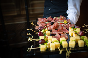 catering services. The waiter keeps snacks - meat and cheese