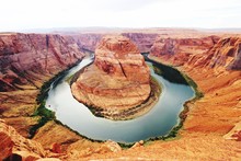 Colorado River Meanders Around Rock Formation At Horseshoe Bend