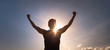 © kieferpix - Victorious man with strong arms up in the sunset sky. People power and hope.