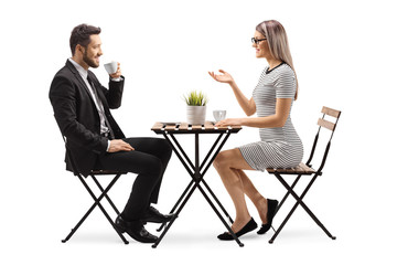 Poster - Young man and woman in a cafe talking and drinking coffee