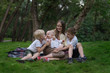 © somemeans - Three kids and amom in a park in clearing. Older siblings for my youngest sister