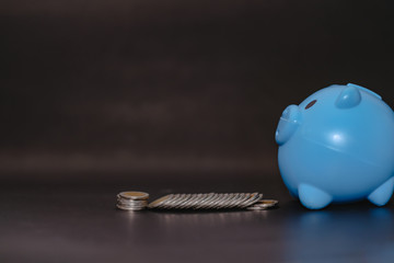 There is money coins to stack of coins. Close up of coins to stack of coins and piggy bank,Money, Financial, Business Growth concept