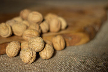 Wall Mural - walnuts over jute fabric and a wooden cutting board