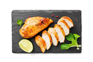 Wall Mural - Grilled chicken breast. Sliced chicken fillet with lime isolated on white background	