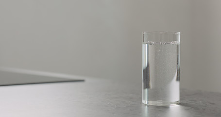 water in highball glass on kitchen countertop