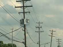 Low Angle View Of Telephone Poles Against Sky