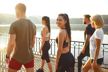 Wall Mural - A group athletes are smiling in training in a city park