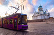 Public transport in Helsinki. The tram goes near the Church of St. Nicholas in the Finnish capital. Lilac tram on the Senate square in Helsinki. Temples Of Scandinavia.