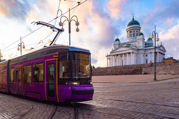 Wall Mural - Public transport in Helsinki. The tram goes near the Church of St. Nicholas in the Finnish capital. Lilac tram on the Senate square in Helsinki. Temples Of Scandinavia.