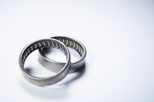 A Pair Of Needle-bearing Roller Bearings On A Gray Background. The Concept Of New Car Parts