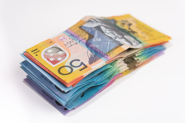 pile of australian money with 50 dollar note on top