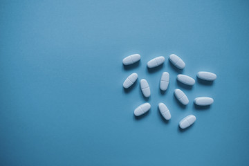 Wall Mural - White pills  on a paper background with a free area for text